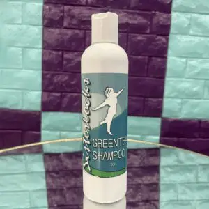 Bottle of green tea shampoo with a dancing couple logo.